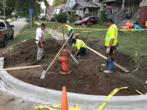 Men at work constructing a neighborhood sidewalk